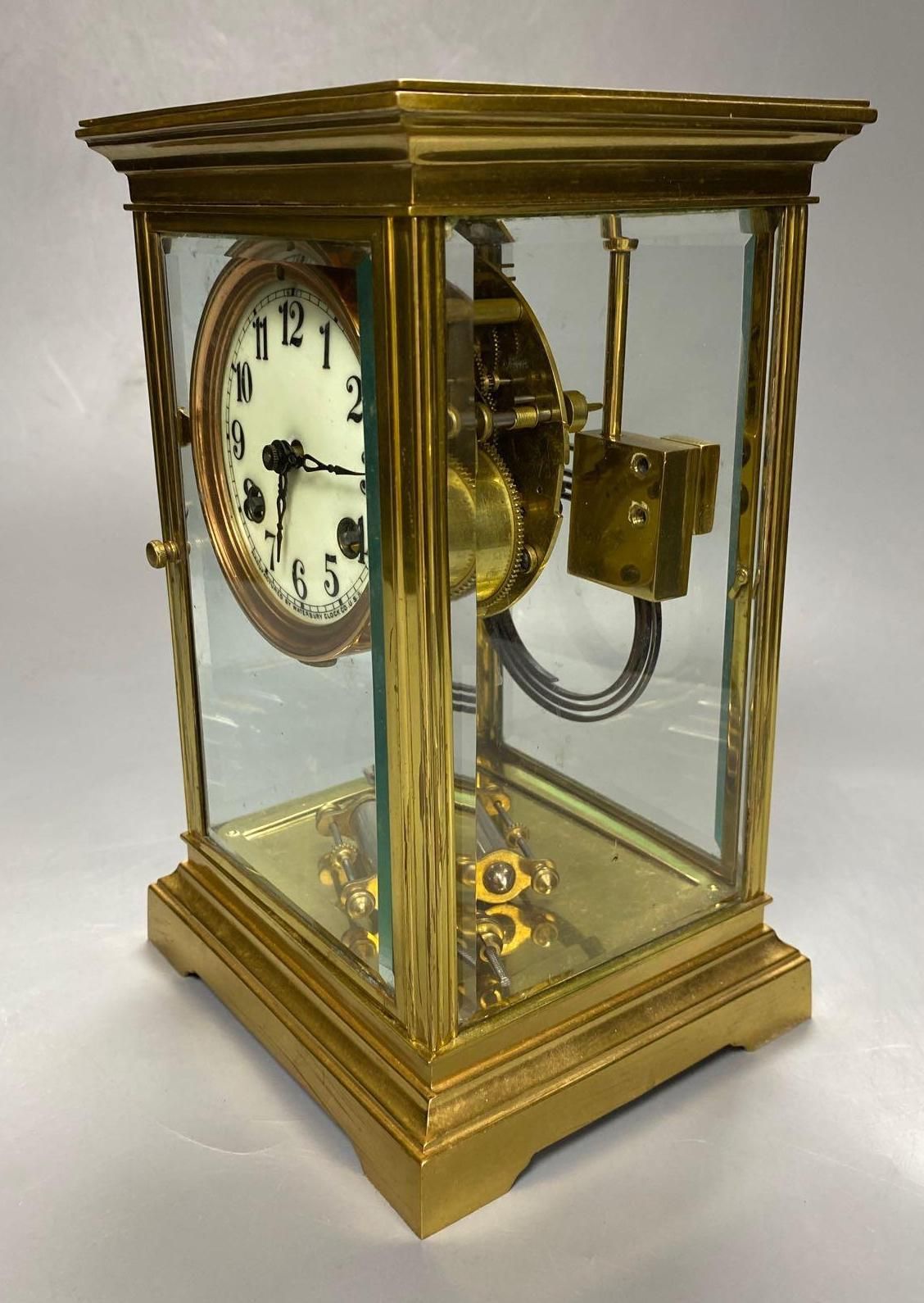 A lacquered brass four-glass mantel clock, Waterbury Clock Co., USA, gong striking movement, height 24cm